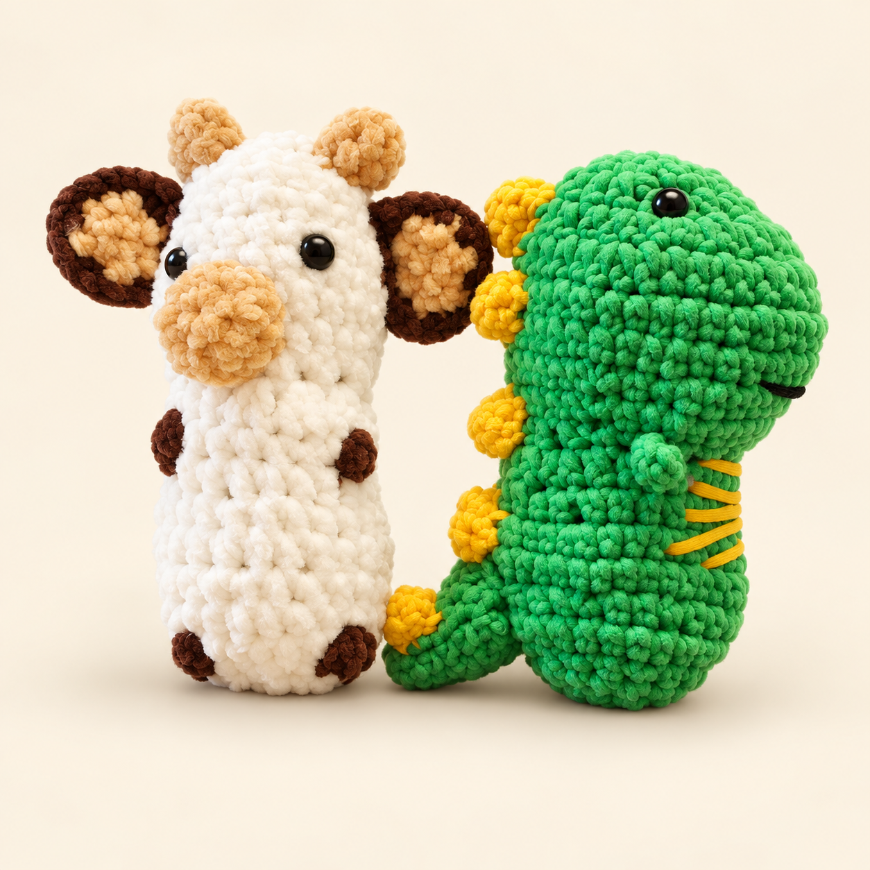 Kelsie’s handmade cow and dinosaur samples together on a soft studio background
